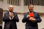 Profesor Stanisław Mikołajczak prezentuje otrzymany medal